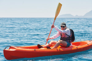 Boat kayaking near cliffs on a sunny day. Travel, sports concept. Lifestyle Boat kayaking near cliffs on a sunny day. Travel, sports concept. Lifestyle