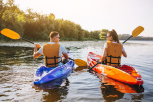 Couple together kayaking on the river Couple together kayaking on the river